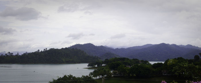 Scenic view of mountains and river against sky