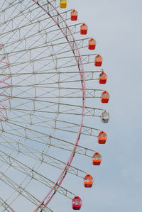 Low angle view of ferris wheel against sky