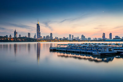 Reflection of buildings in city at waterfront