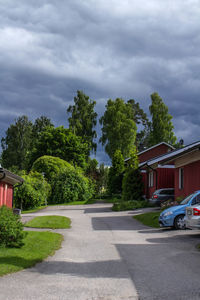 Road amidst trees against sky