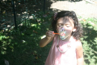 Close-up of boy playing with bubbles