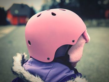 Close-up of child wearing pink helmet