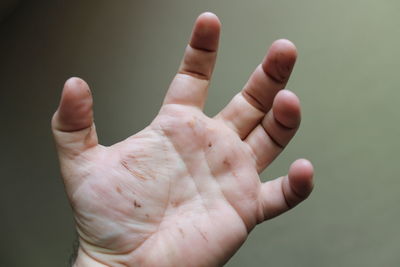 Close-up of human hand against gray background