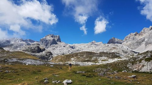 Man walking on mountains against sky