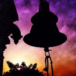 Low angle view of silhouette trees against sky at sunset