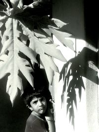 Low angle view of girl standing in front of wall