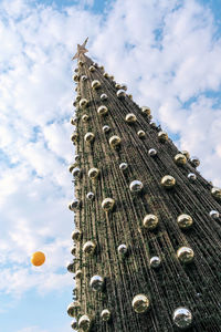 Outdoor christmas tree at daytime with beautiful blue sky