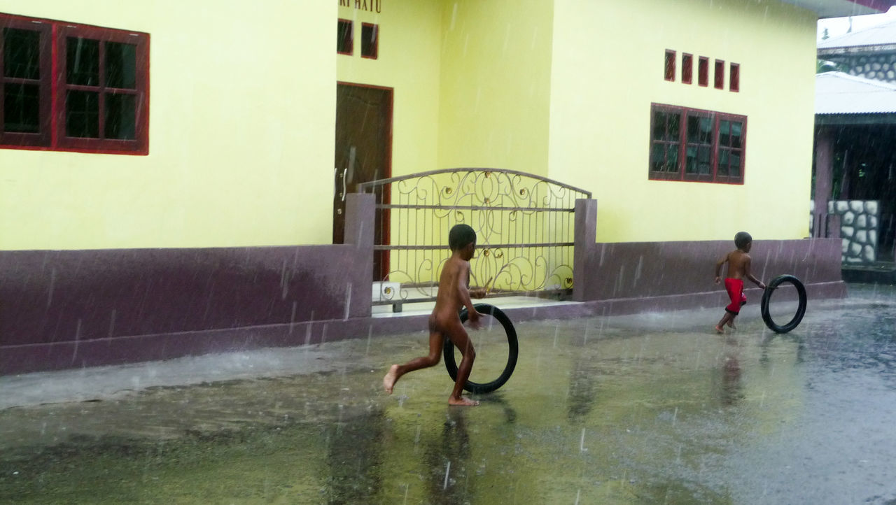 FULL LENGTH OF WET MAN IN BUILDING