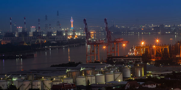 Illuminated cityscape against sky at night