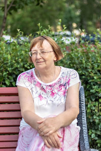 Midsection of woman sitting on seat