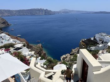 High angle view of townscape by sea against sky