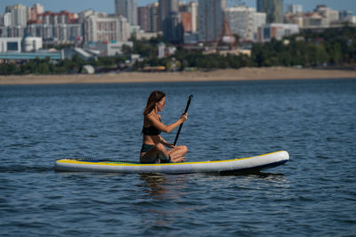 Man with woman in boat on sea