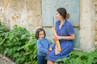 Mother and handsome baby boy walking outdoor in old city park