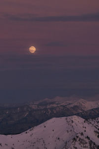 Scenic view of snowcapped landscape against sky at night