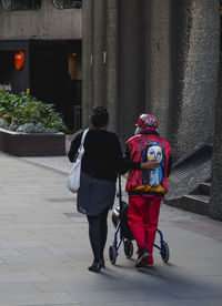 Rear view of women walking on street