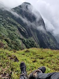 Low section of man sitting on mountain