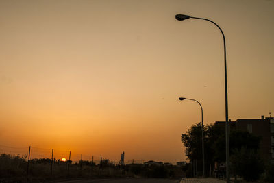 Street light against sky at sunset