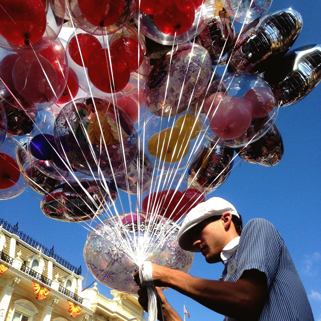 LOW ANGLE VIEW OF ILLUMINATED AMUSEMENT PARK AGAINST SKY