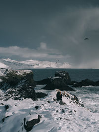 Scenic view of sea against storm clouds