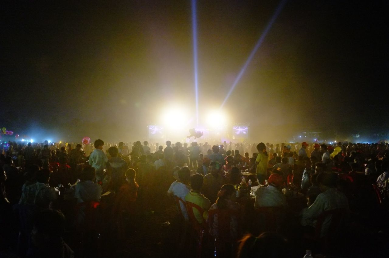 large group of people, crowd, illuminated, person, lifestyles, night, arts culture and entertainment, leisure activity, enjoyment, men, event, music, performance, fun, music festival, nightlife, celebration, togetherness