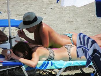 Rear view of woman sitting on bench