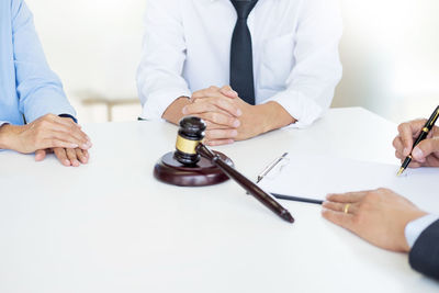 High angle view of couple with judge at desk