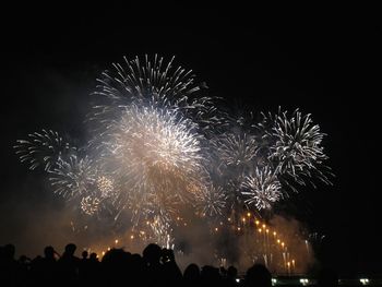 Low angle view of firework display at night