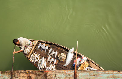 High angle view of man on boat against lake