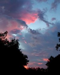 Low angle view of silhouette trees against sky during sunset