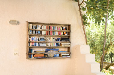 Books on shelf against wall