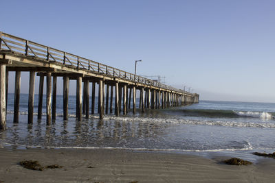 Pier over sea against clear sky