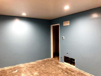 Illuminated light fixture on wall of building