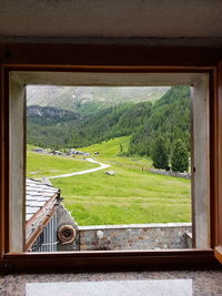 Scenic view of landscape seen through window