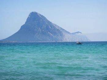 Idyllic shot of boat in sea against tavolara island