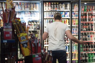 Rear view of man standing in store