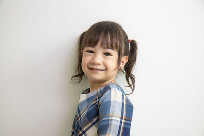 Portrait of a smiling girl over white background