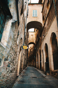 Narrow alley amidst buildings in city