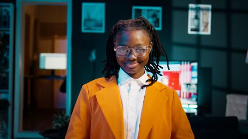 Portrait of young man wearing sunglasses while standing in city