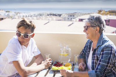 People wearing sunglasses sitting at dining table in restaurant