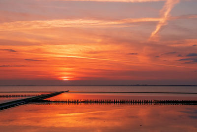 Scenic view of sea against romantic sky at sunset