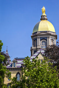 Low angle view of cathedral against clear blue sky in university of notre dame