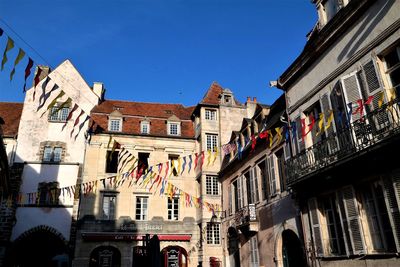 Low angle view of buildings against clear blue sky