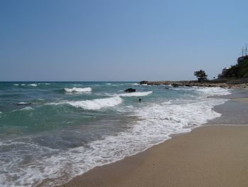 Scenic view of beach against clear sky