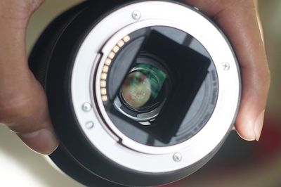 Close-up of man photographing camera