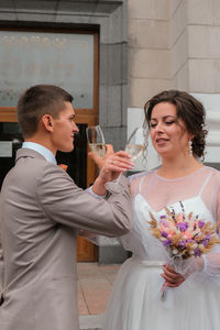 Bride and groom holding wedding glasses with champagne. celebrating just married. lovely coule. love