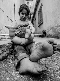 Cute boy sitting on stone