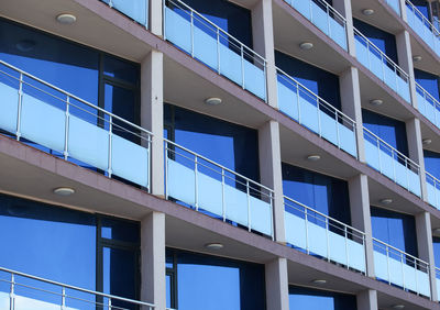 Low angle view of modern building against blue sky