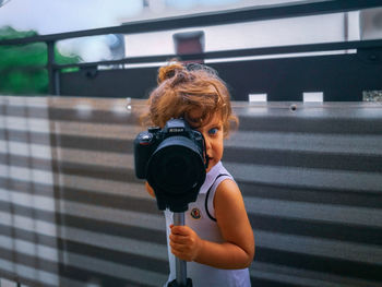 Portrait of woman photographing