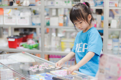 Full length of girl looking at store