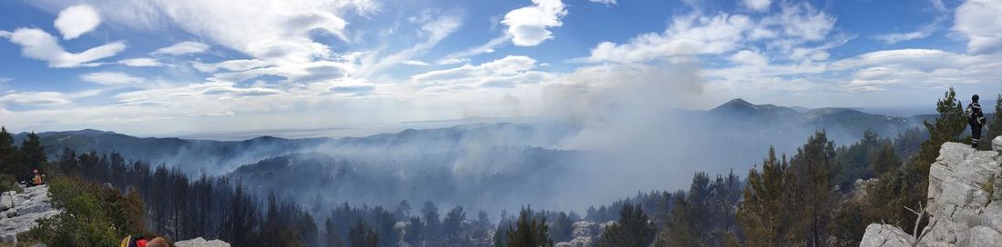 Panoramic view of forest fire from ridge above